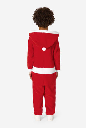 Back view of a child wearing a red Santa onesie with a white-trimmed hood and a small white pom-pom.