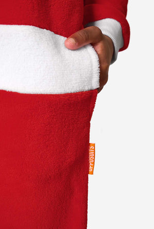 Close-up of a child’s hand in the pocket of a red Santa onesie, showing the white waistband trim and an orange OppoSuits label.
