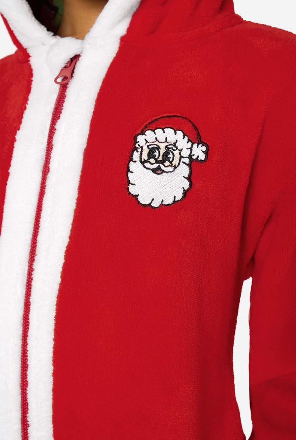 Close-up of the chest area of a red Santa onesie featuring a white zipper trim and a small embroidered Santa head.