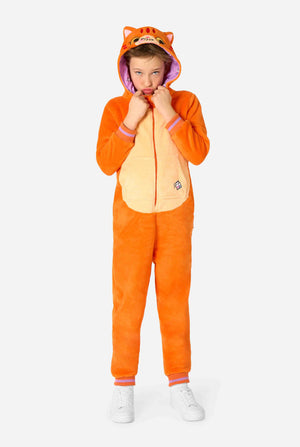 Child wearing a playful unisex kids onesie designed as a red-orange cat, featuring a hood with a cartoon cat face, ears, and a light beige belly panel, making a silly face against a plain background. Full body.