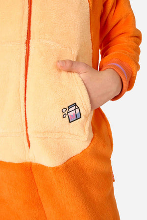Child wearing a playful unisex kids onesie designed as a red-orange cat, featuring a hood with a cartoon cat face, ears, and a light beige belly panel, making a silly face against a plain background. Focused on a hand in a pocket