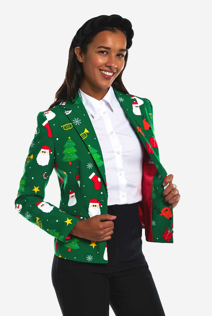 Woman wearing green Christmas blazer for women, with Christmas icons on it.