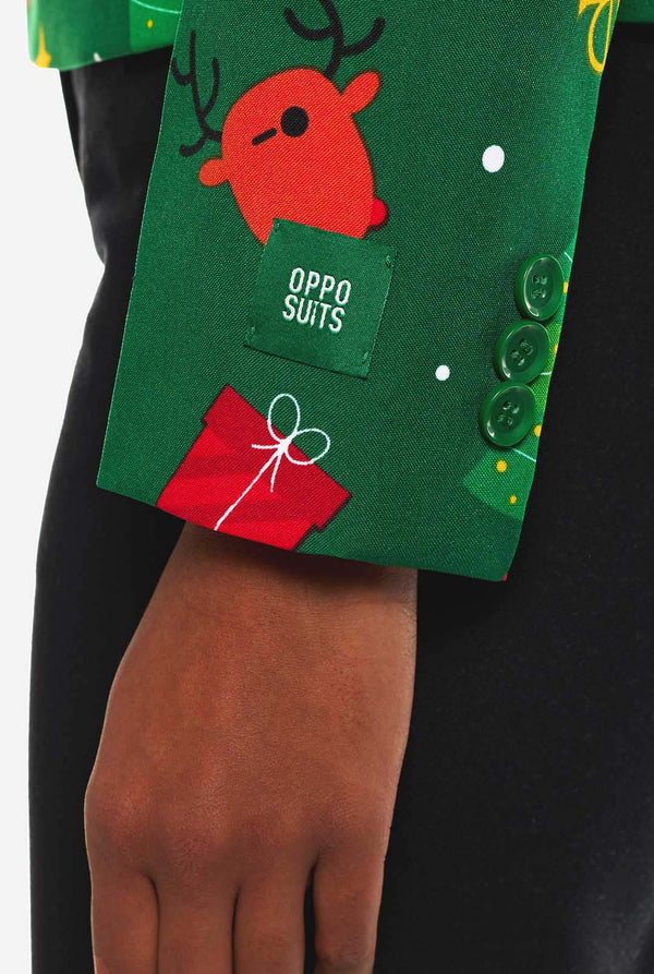 Woman wearing green Christmas blazer for women, with Christmas icons on it.