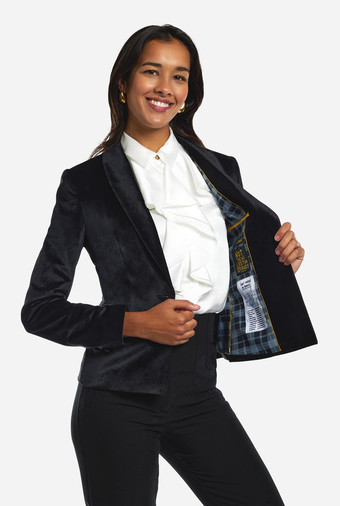 Woman wearing black velvet dinner jacket blazer