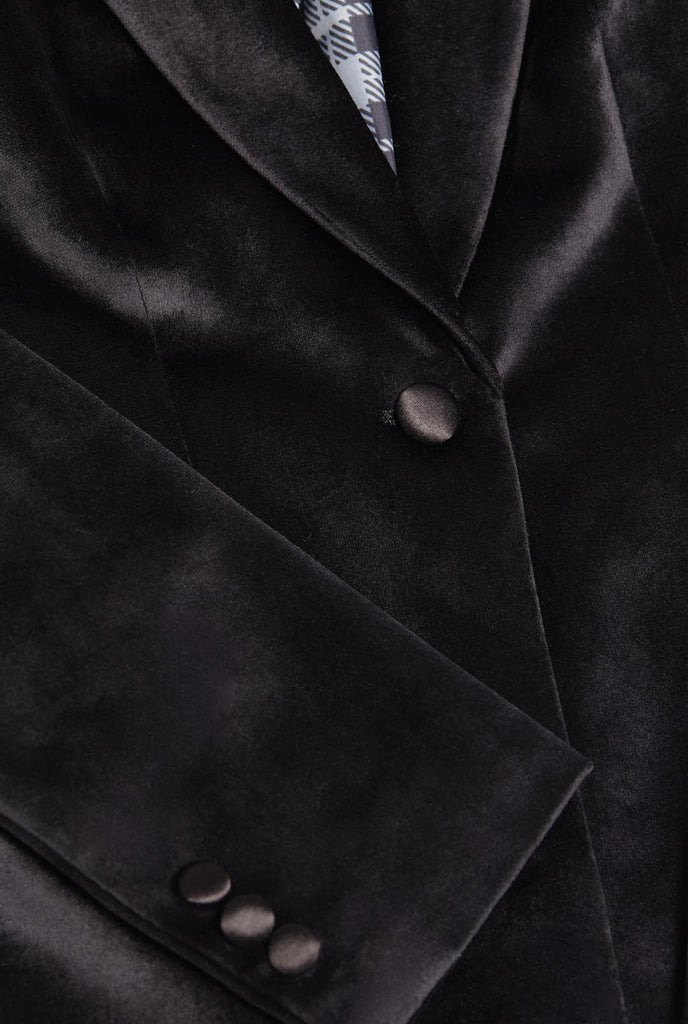 Woman wearing black velvet dinner jacket blazer
