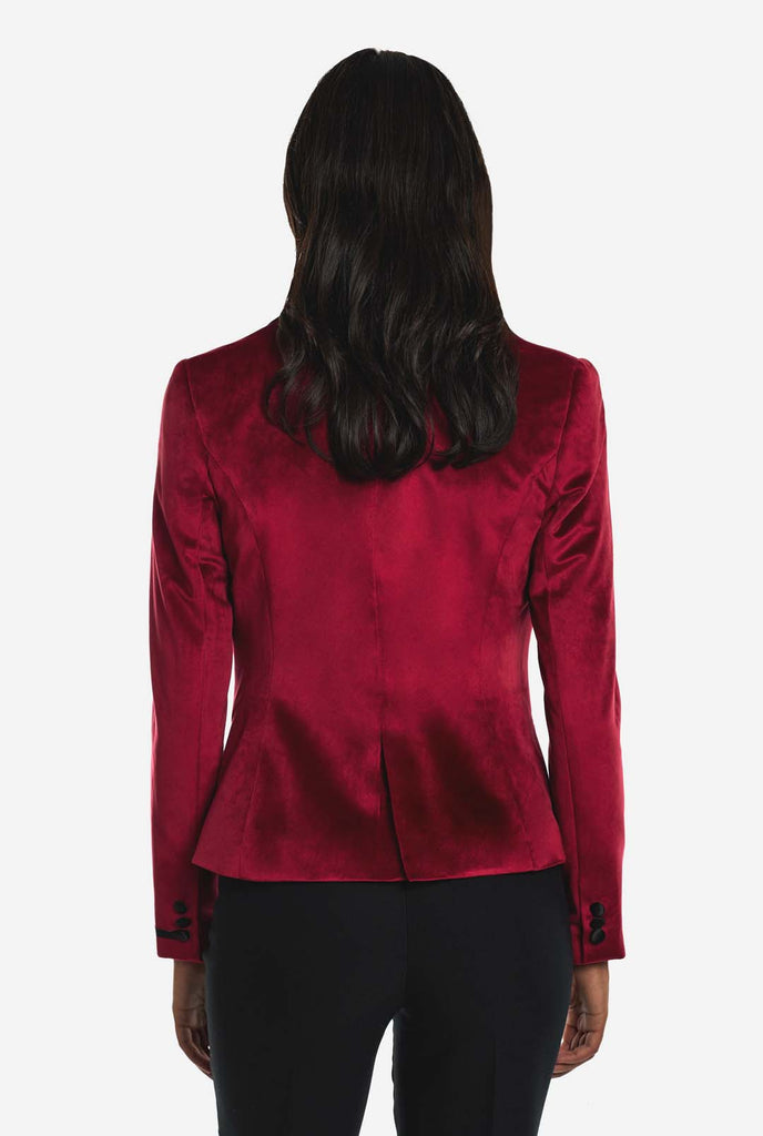 Woman wearing burgundy red velvet dinner jacket blazer