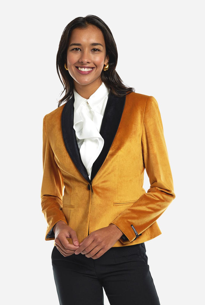 Woman wearing golden velvet dinner jacket blazer