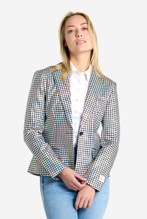 Woman wearing a checkered discoball blazer over a white shirt with a plain background