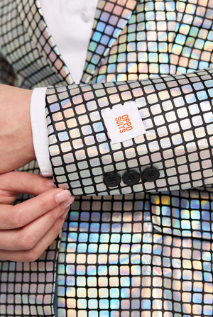 Close-up of a person wearing a colorful, discoball patterned garment with a visible brand logo.