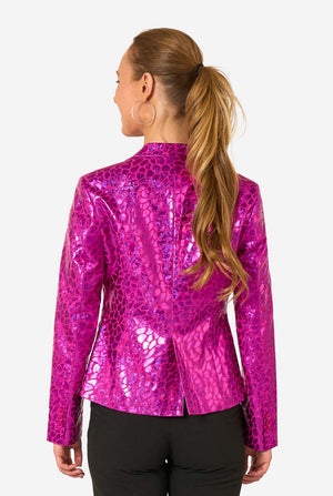 Back view of a woman wearing a shiny hot-pink blazer with an abstract textured pattern and long hair tied in a ponytail.
