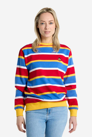 Woman wearing a colorful striped sweater with a plain background