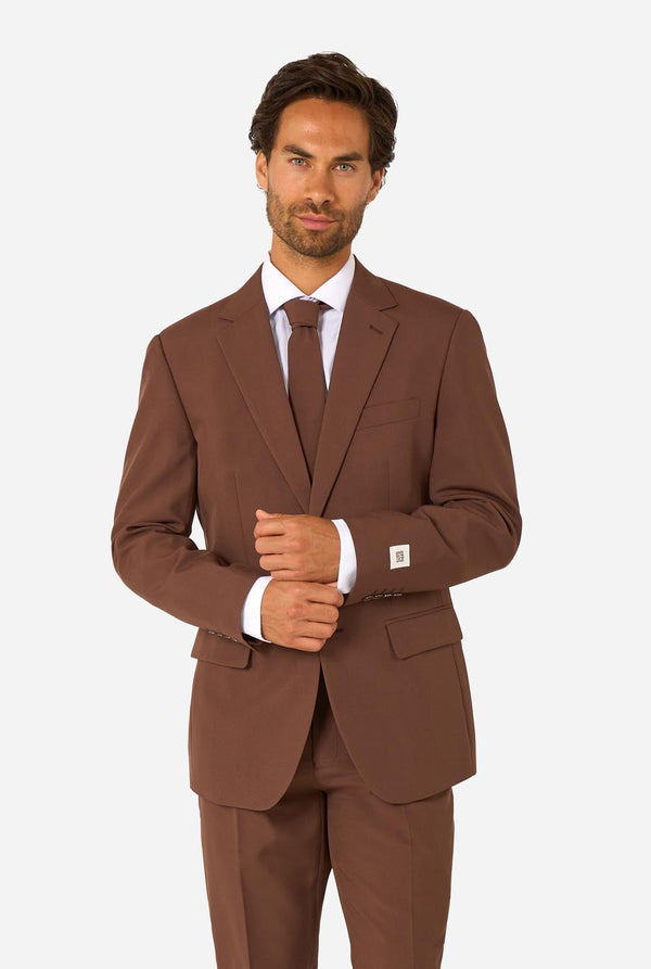 Man wearing a brown suit with a white shirt and tie on a white background
