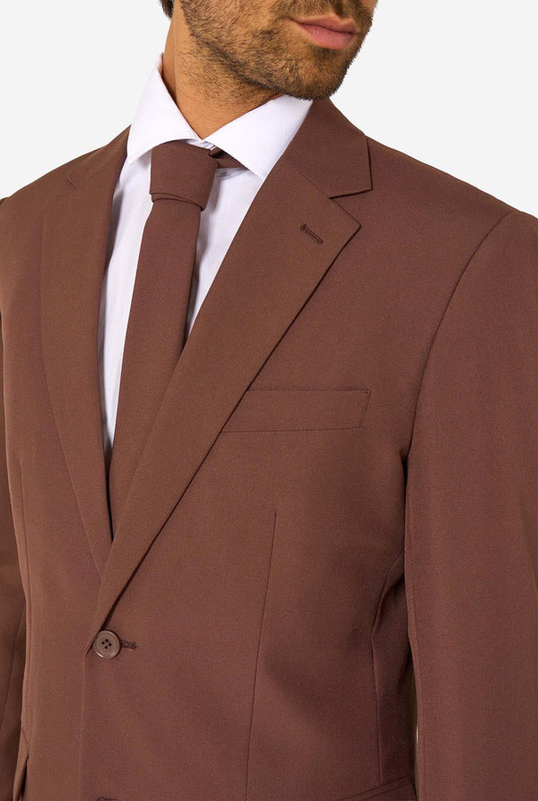 Brown suit jacket with a white shirt and tie on a plain background