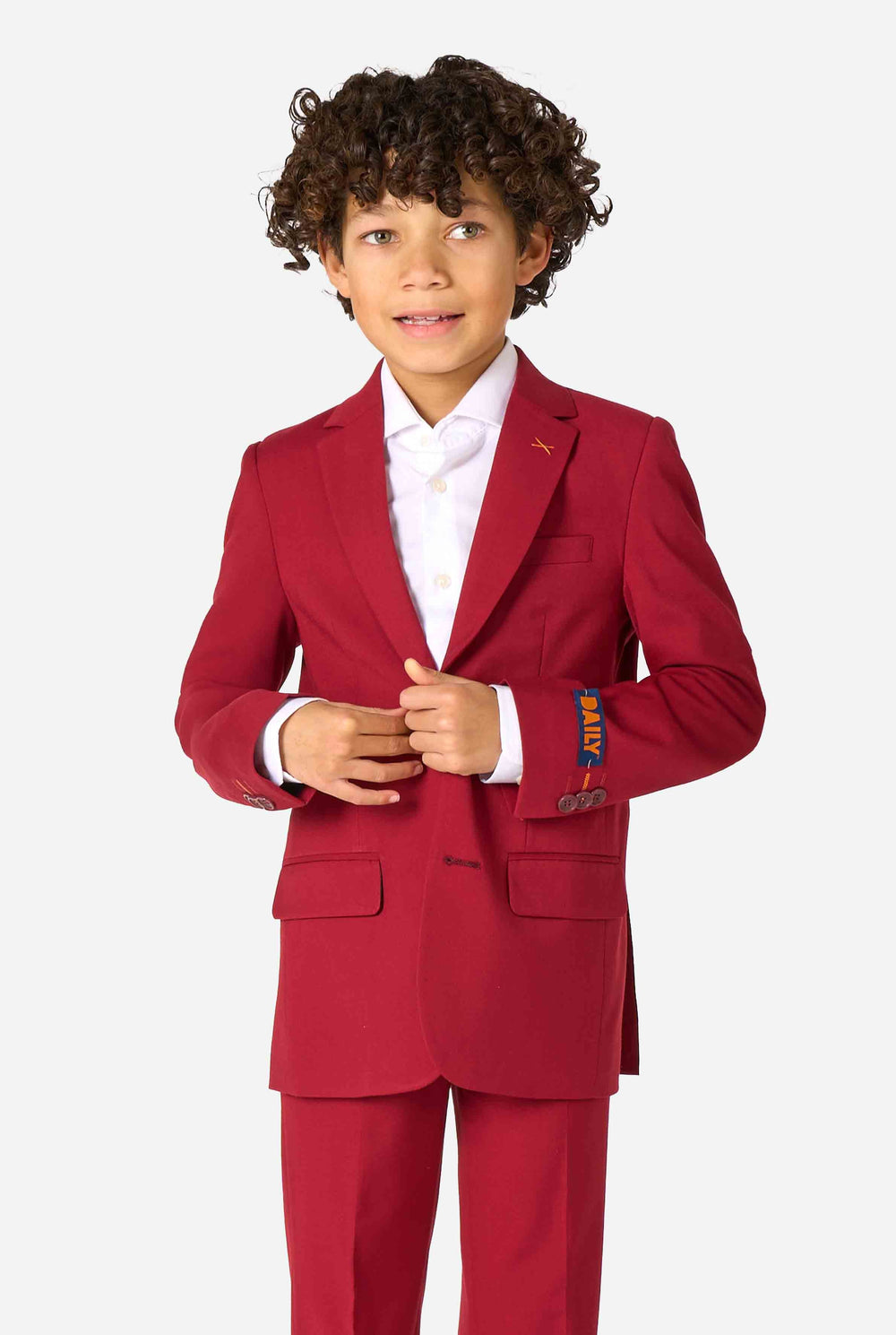 Kid wearing a stylish burgundy red suit with a white dress shirt, looking confidently. Perfect formal outfit for boys' special occasions, weddings, and parties.