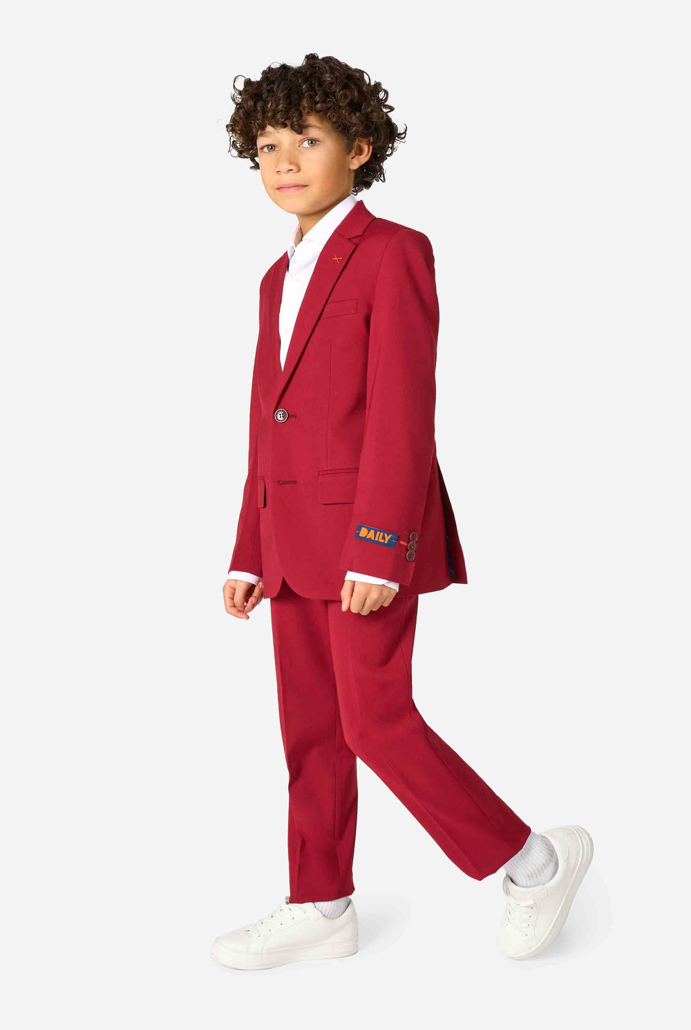 Kid wearing a stylish burgundy red suit with a white dress shirt, looking confidently. Perfect formal outfit for boys' special occasions, weddings, and parties.