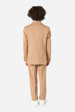 Kid wearing a stylish light brown/ beige suit with a white dress shirt, looking away from the camera. Perfect formal outfit for boys' special occasions, weddings, and parties. View from the back.