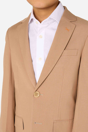 Kid wearing a stylish light brown/ beige suit with a white dress shirt, looking away from the camera. Perfect formal outfit for boys' special occasions, weddings, and parties. Focused on the chest.