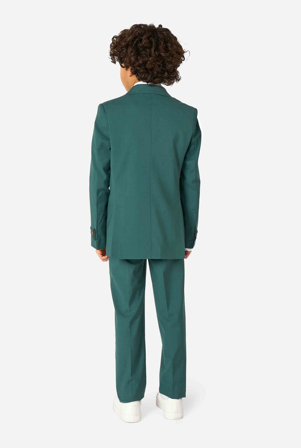 Kid wearing a stylish dark green suit with a white dress shirt, looking away from the camera. Perfect formal outfit for boys' special occasions, weddings, and parties. View from the back.