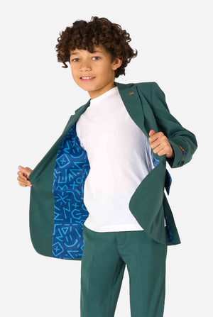 Kid wearing a stylish dark green suit with a white dress shirt, looking away from the camera. Perfect formal outfit for boys' special occasions, weddings, and parties. Playfully holding the jacket open.