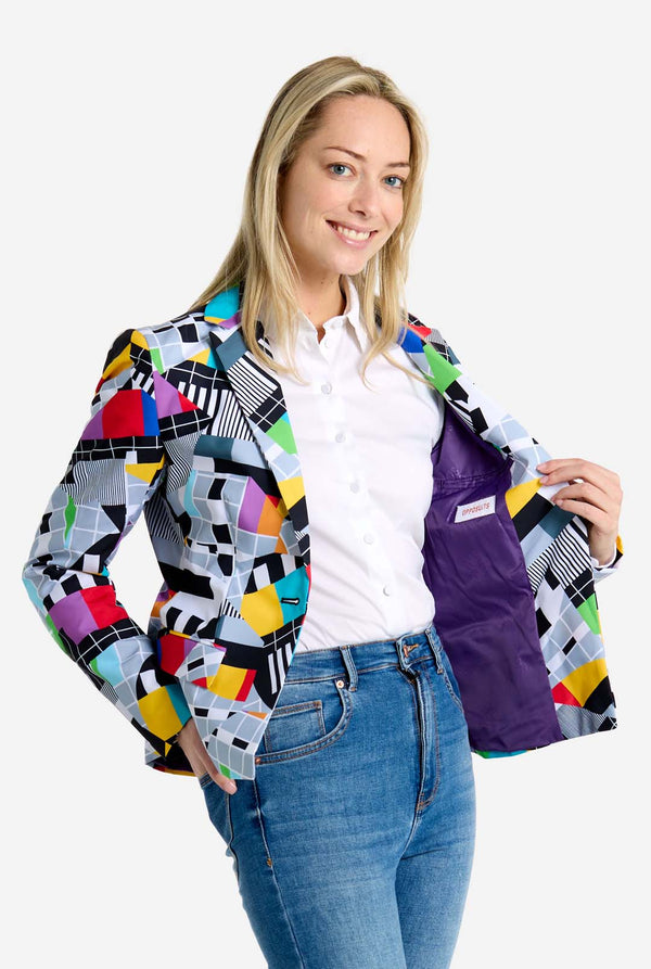 Woman wearing a colorful patterned jacket on a white background