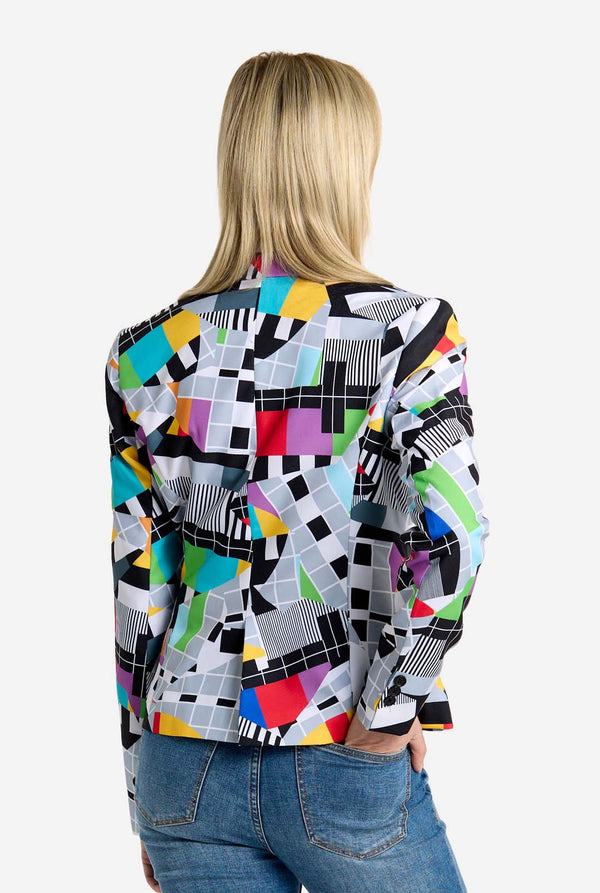 Person wearing a colorful geometric patterned shirt on a white background