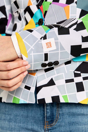 Person holding a deck of cards with geometric pattern and visible brand logo.