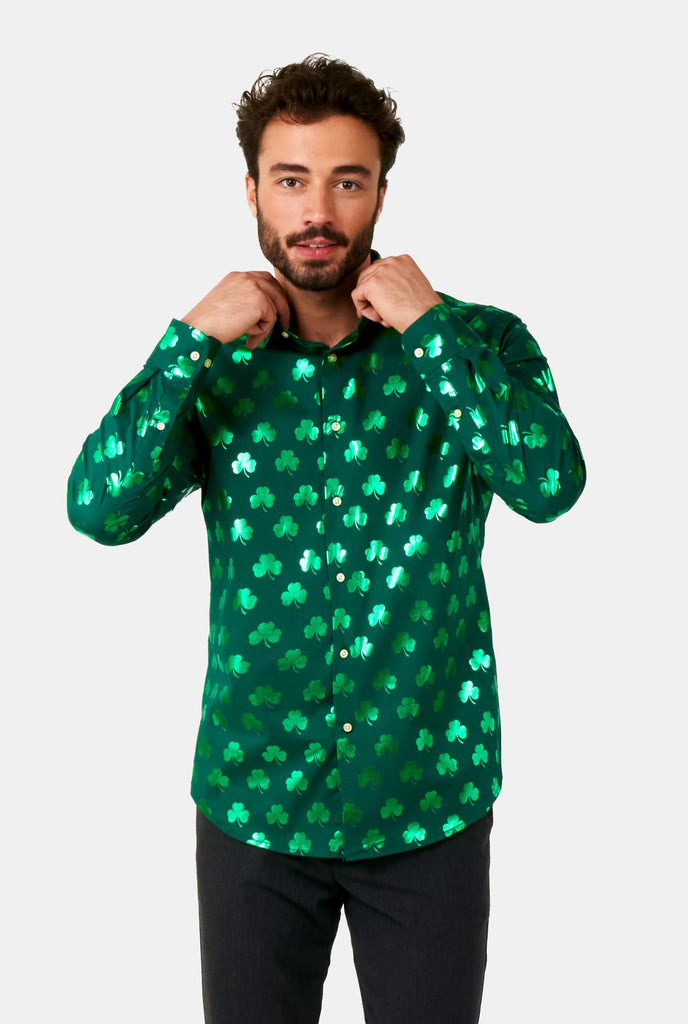 Man wearing Green St Patrick's Day shirt with green shiny clovers.